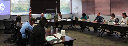 Board of Education members seated at a table